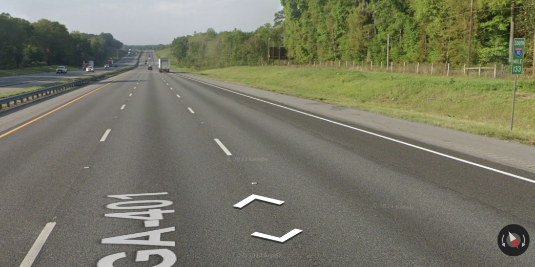 a road with trees and grass